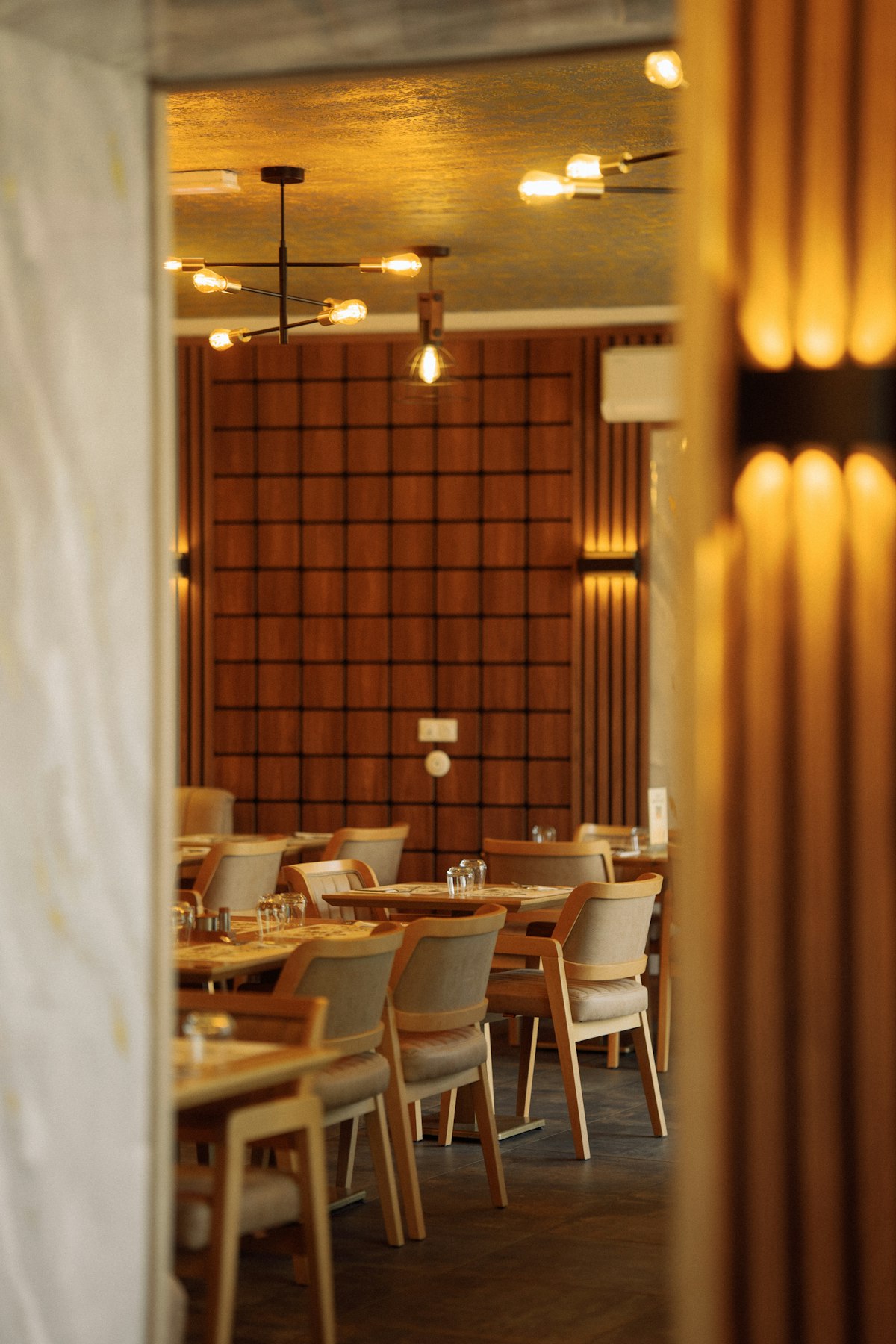 Warm wood restaurant dining room with pendant lights